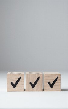 Three wooden blocks each marked with a black checkmark symbolizing