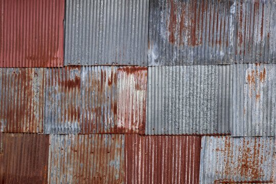 Artistic of old and rusty zinc sheet wall. Vintage style metal sheet roof texture. Pattern of old metal sheet. Rusting metal or siding. Corrosion of galvanized. Background and texture in retro concept