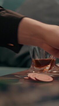 Close up unrecognizable Caucasian male dealer shuffling cards poker chips home casino card man guy businessman croupier playing gaming gambling play blackjack drinking alcohol whiskey smoking cigar