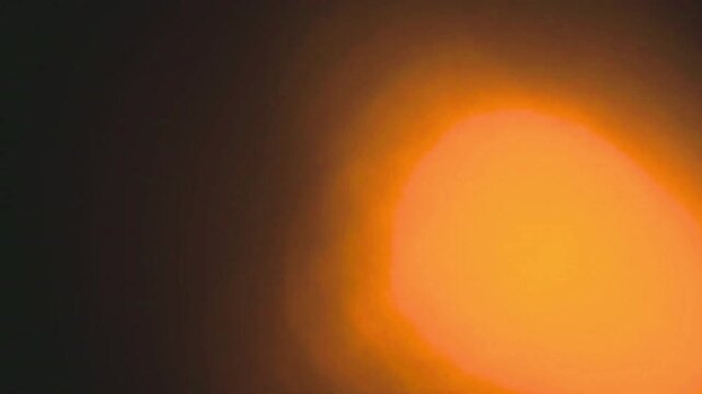 Old damaged film strip texture with burn marks and scratches in warm orange tones