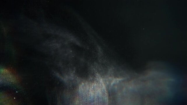 Dust particles floating in air with chromatic aberration hallucination effect, abstract particle overlay on black background macro slow motion