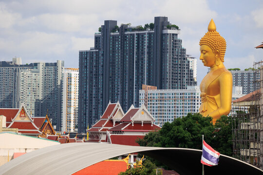 Wat Paknam golden buddha statue overlooking Bangkok urban cityscape