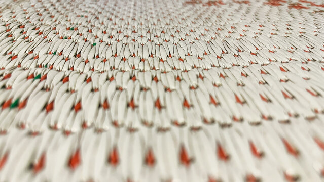 close up view of Traditional mat or tikar texture. pattern. detail, detailed. white, red. indonesia. copy space, empty, free, negative, text, design. front, side. background, backgrounds.