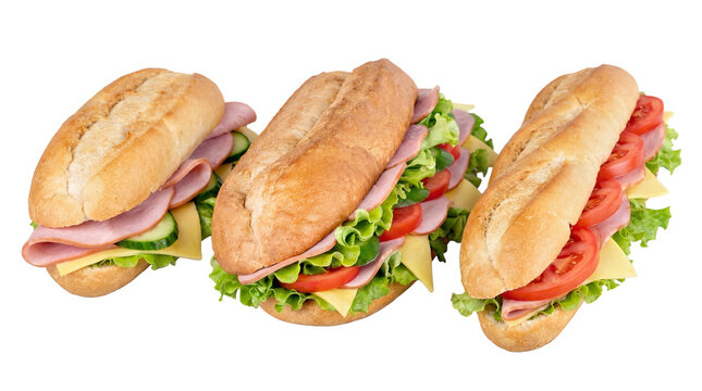 Three delicious fresh sub sandwiches with ham, cheese, and crisp vegetables, photographed in a studio.