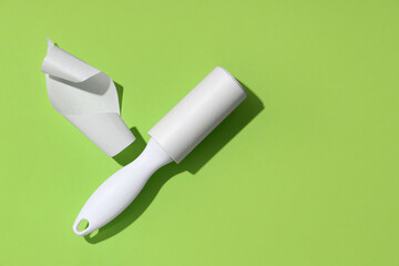Sticky lint roller on green background