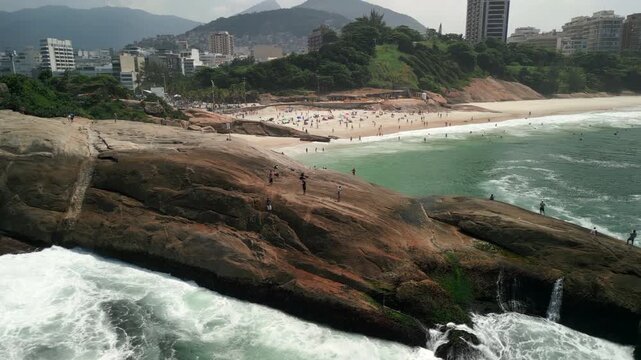 Right aerial traverse panning left over Ipanema around Arpoador Rock, revealing Morro dois Irm&atilde;os - Two Brothers Mountain and city during tropical day. Recorded at 4K Apple ProRes 422.