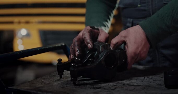 mechanic inspecting heavy duty engine rocker arm parts in workshop