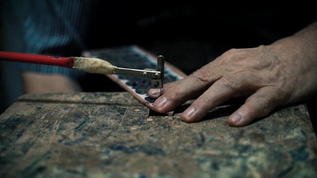 artisan using fret saw for intricate pattern detail on craft material