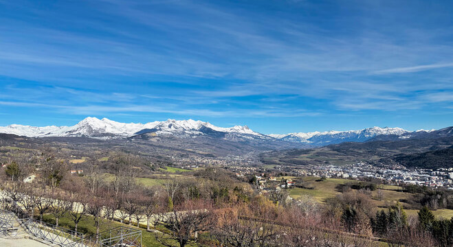 View over the snow capped French Alps mountains in distance from Domaine de Charance, France.