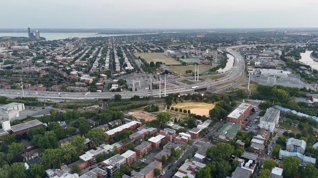 Aerial drone view of Turcot Interchange, Lachine Canal and baseball field at dusk in Montreal, Quebec, Canada. g.