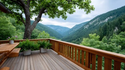 Obraz premium Wooden deck overlooking green mountain valley and forest