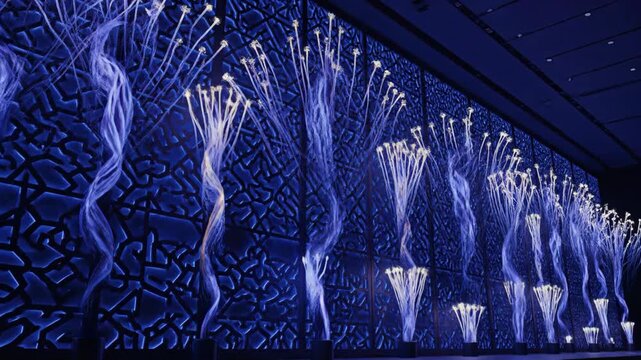 Modern architecture with geometric blue pattern and lighting design creating a unique architectural abstract.