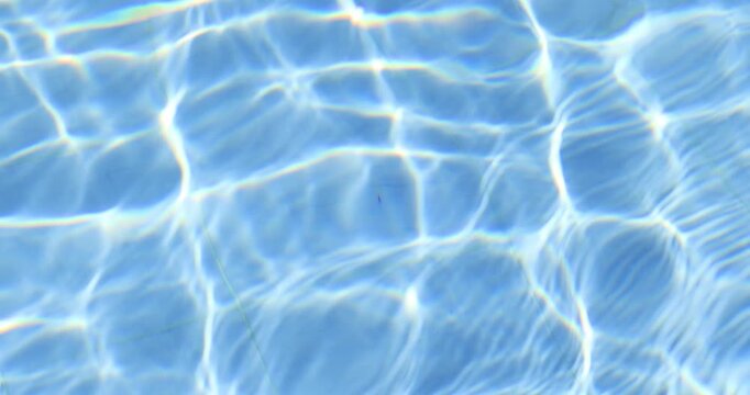 abstract blue swimming pool water with shimmering light reflections and gentle moving ripples, perfect for summer, relaxation, refreshing background, and luxury pool concepts