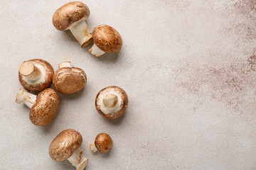 Raw champignon mushrooms on white grunge background, closeup
