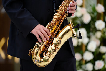 Obraz premium Jazz Day Man in black suit playing golden saxophone at formal event music musician