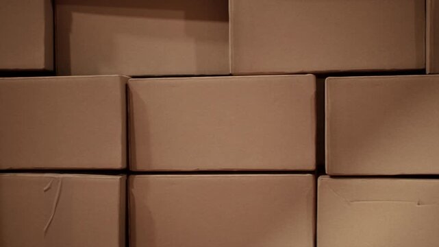 Closeup stack of cardboard logistics shipping boxes in warehouse. 3D animation. 4K. Logistics Idea concept.	
