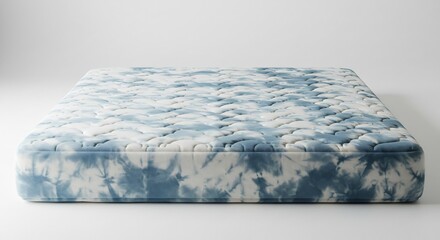 Fototapeta premium Soft comfortable mattress featuring a vibrant blue and white tie-dye pattern beautifully lit in a clean studio setting. AI Generated