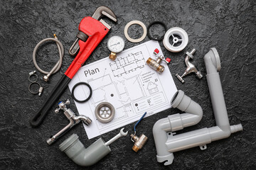Composition with plumber's items and house plan on dark background