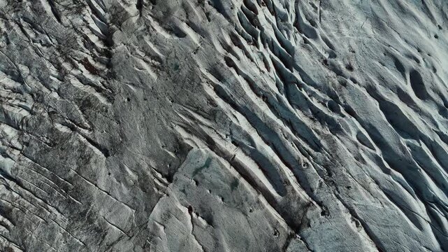 Detailed glacier ice texture with crevasses and blue ice patterns viewed from above, Norway. Aerial