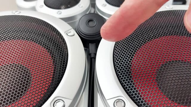 Hidden camera positioned between speakers, showcasing discreet surveillance setup and monitoring equipment for security, observation, and technology demonstration purposes