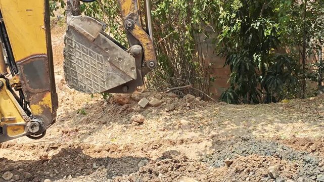 Backhoe loader moving through a construction area