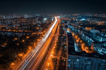 Fototapeta premium Aerial view, night city traffic, long exposure light trails on a major avenue, dark tones, hyperdetailed,