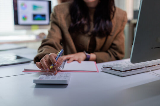 Person calculating expenses and managing personal finance