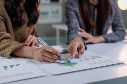 Businesswomen discussing financial data during an office meeting