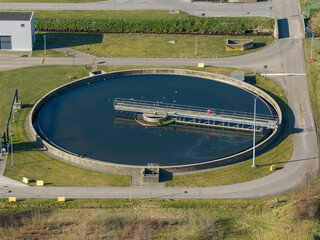 Circular clarifier tank at wastewater treatment plant aerial view showing sedimentation basin for sewage purification. Infrastructure for municipal sanitation, environmental protection. Ecology, water