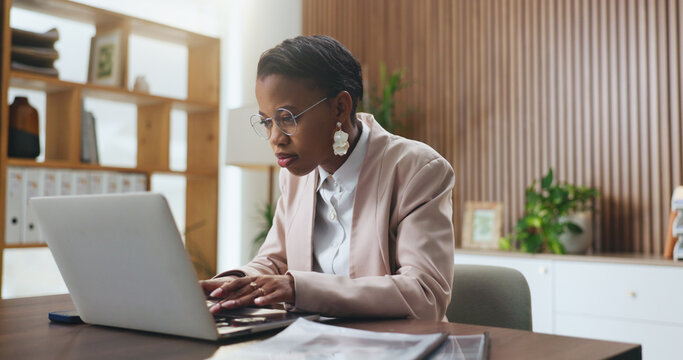 Black woman, laptop and typing in office for lawsuit research, case preparation and drafting legal report. Business attorney, employee and technology for online court review, planning and email