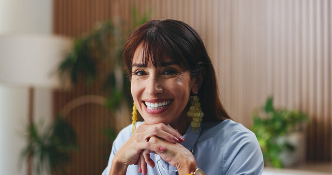Woman, broker and smile in portrait at office with actuarial advisor, pride or employee at insurance company. Mature person, consultant and happy for confidence, risk management and agency in Italy