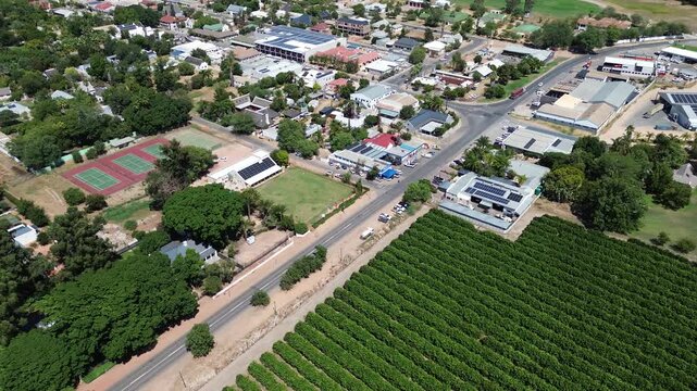 Camera panning up over the town of Clanwilliam and the main road with mountains on the horizon. The town is Famous for Rooibos tea and fruit. 4K Aerial Video.