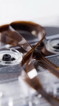 Old audio cassette tape is pulled out and tangled