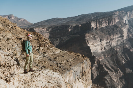 Female hiker on spectacular Balcony trail near Jebel Shams, Oman