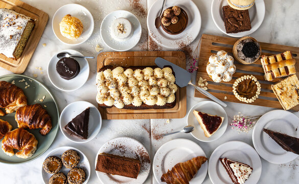 Various desserts, pastries and cakes on a white table