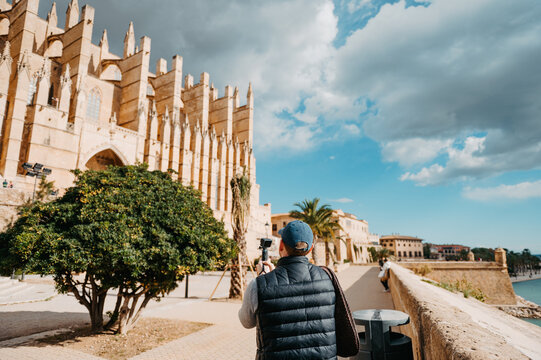 Man filming Palma Cathedral La Seu in Mallorca Spain