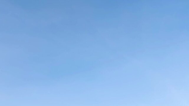 A background with a clear blue sky and soft clouds, minimalist nature-themed wallpaper and a calm atmospheric texture
