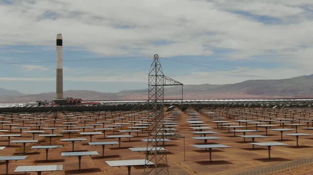 Aerial view of electricity transmission tower inside Noor concentrated solar power plant with heliostat mirror field and solar tower in Ouarzazate Morocco.