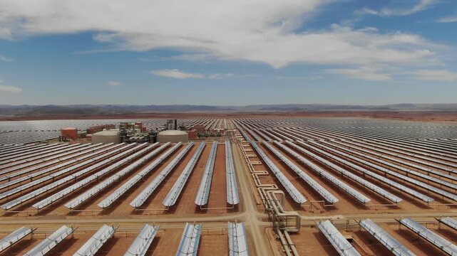 Aerial view of solar thermal collector rows at Noor solar power complex in Ouarzazate Morocco highlighting large scale renewable energy technology in the desert.