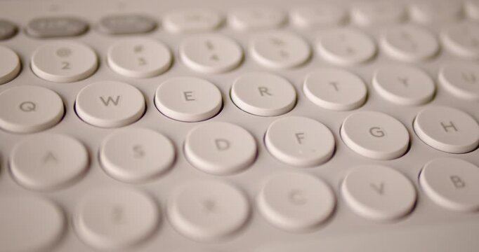 Close up Pan of Round Keys on Modern Slim Bluetooth Keyboard