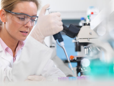 DNA Research, Scientist pipetting a DNA sample into a tube ready for automated analysis in the laboratory