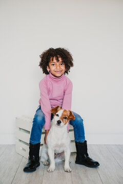 Portrait of smiling little girl and her dog