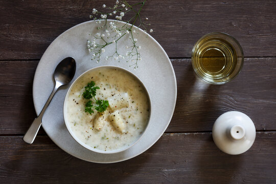 Cream of white asparagus soup garnished with asparagus spears and parsley