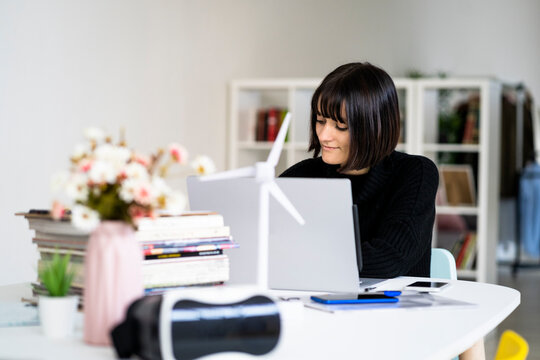 Young female student with concentration studying in study room