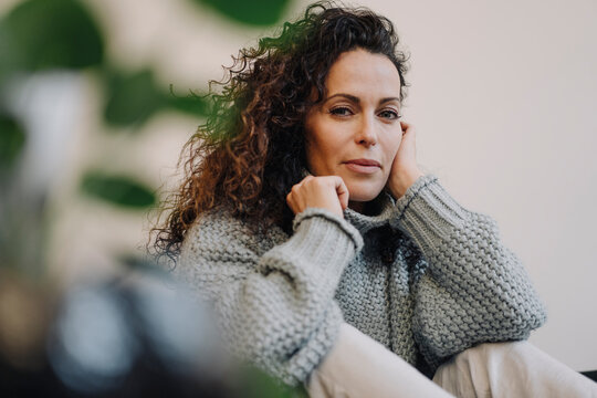 Portrait of a dark haired woman, looking at camera
