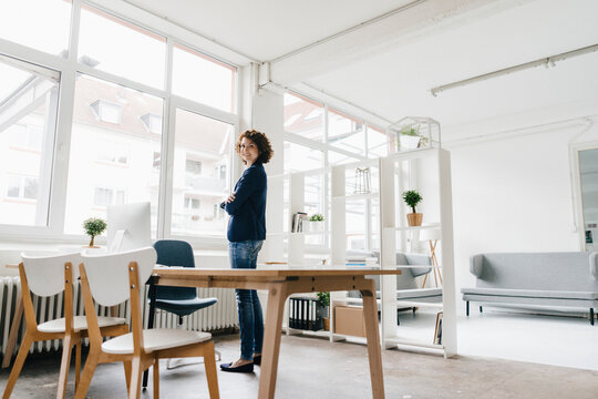 Businesswoman in office, looking confident