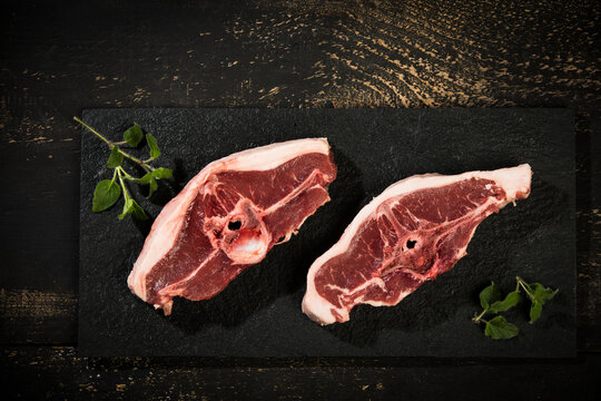 Raw meat, lamb chops on slate