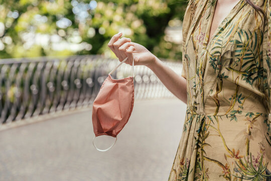 Close-up of woman holding face mask