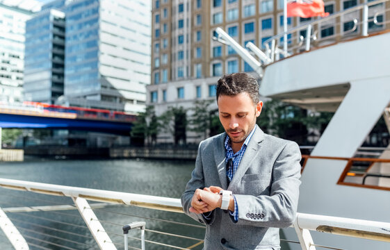 Businessman checking the time in the city