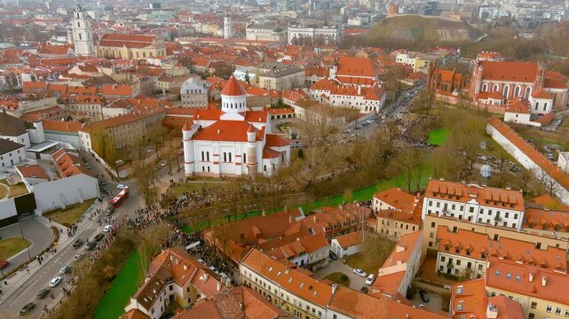 Aerial view of hundreds of people enjoying festivities and celebrating St. Patrick's day in Vilnius. Vilnele river was dyed green to mark the patron saint of Ireland's day.